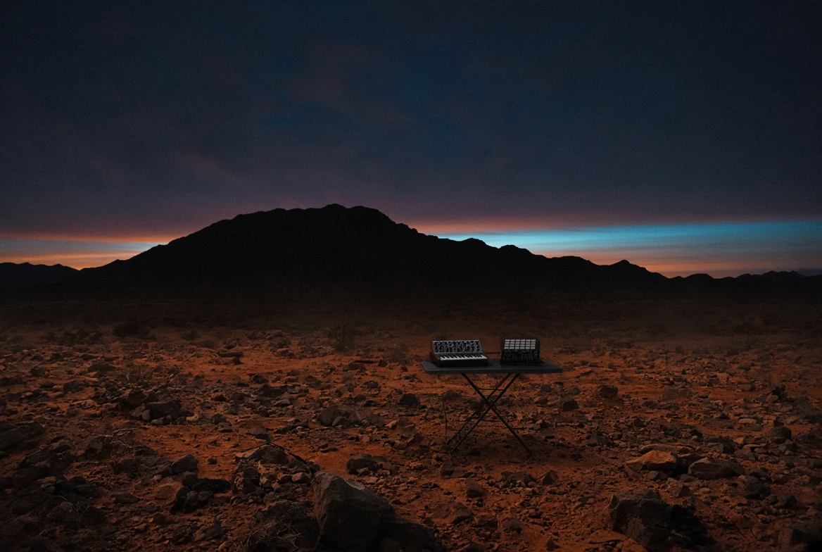 HEARO live rig sitting small in the Arizona high desert at dusk, cyan band on the horizon