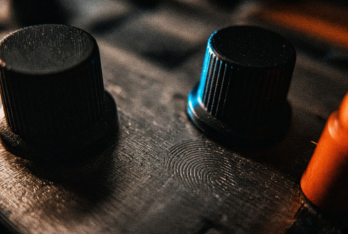Extreme close-up: two knobs and a fingerprint